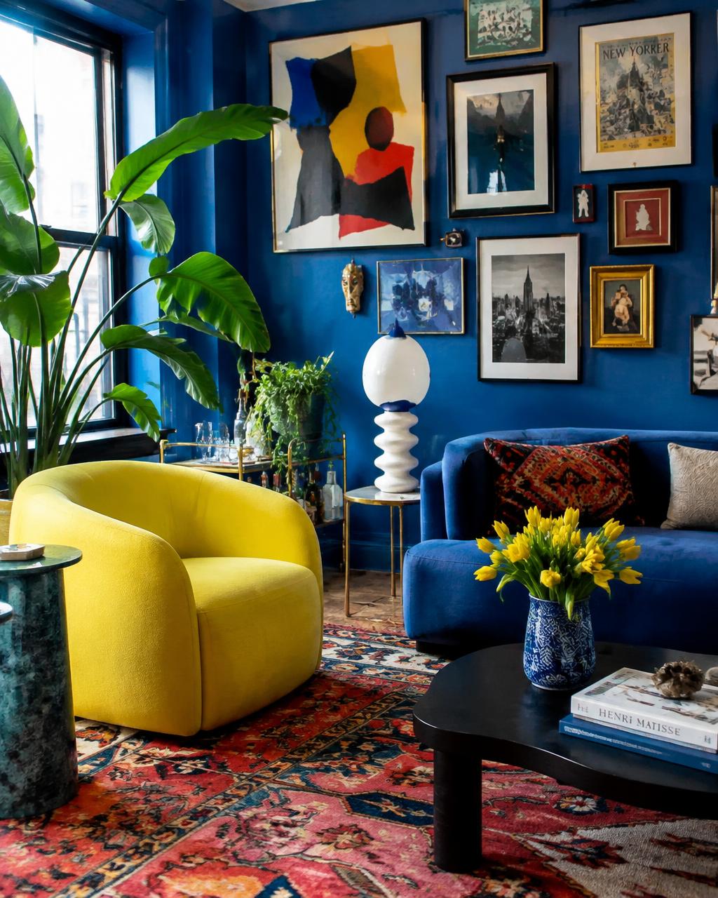 Cobalt blue living room with acid yellow chair, gallery wall and Persian rug